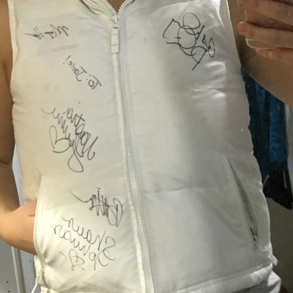 White puffer vest signed by Olympic gymnasts